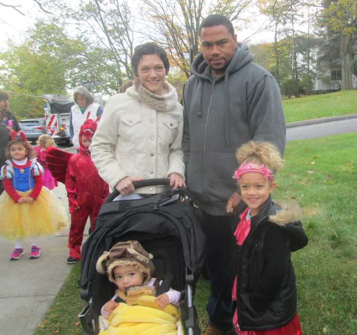 A monkey and Princess Elena pose with their parents at the Briarcliff Ragamuffin Parade.