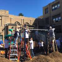 <p>Volunteers work last Wednesday to get the playground up.</p>