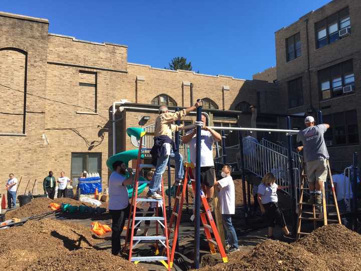 Volunteers work last Wednesday to get the playground up.