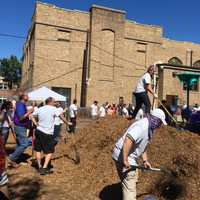 <p>Volunteers dig holes for the new playground in the extended planning phase of the project.</p>