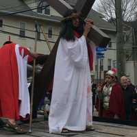 <p>Hundreds processed down East Main Street on Good Friday, stopping to commemorate the Catholic Stations of the Cross.</p>