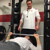 <p>Junior Travis Talarico, a Bucknell commit, benches close to 200 pounds with Robinson spotting.</p>