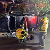 <p>The mangled SUV was righted and removed on a flatbed tow truck.</p>