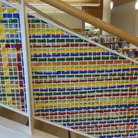 <p>Artist Katherine Daniels created an art installation of colorful plastic strips woven into the gridded surround of Greenwich Library&#x27;s grand stairs.</p>