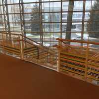 <p>Artist Katherine Daniels created an art installation of colorful plastic strips woven into the gridded surround of Greenwich Library&#x27;s grand stairs.</p>