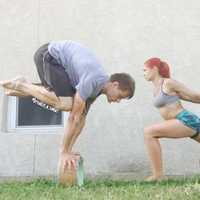 <p>Michael Taylor and Jessica Morfa using yoga wheels.</p>