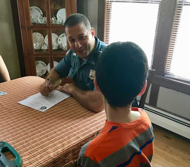 Paramus Police Officer Lou Cardone enrolls a new member in the department&#x27;s Residents Identification Program.