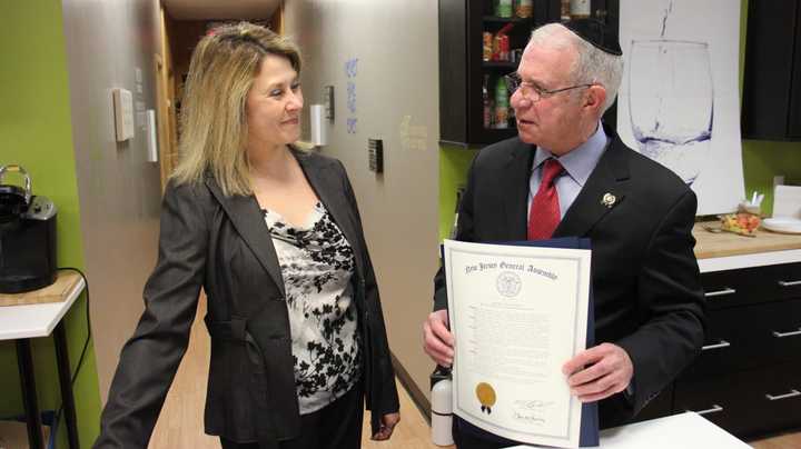 Assemblyman Gary Schaer presents Weight Wellness Center Owner Jennifer Burns Katafigiotis with a proclamation from the State of New Jersey honoring her efforts. The proclamation was co-sponsored by Schaer and Assemblywoman Marlene Caride.