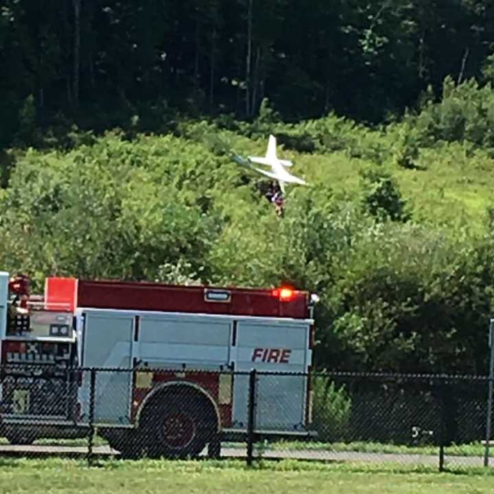 Fire and police are on the scene of plane crash on a hill above the dog park near the Danbury Airport on Sunday morning.