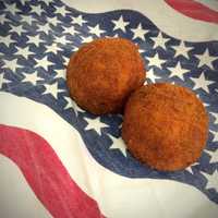 <p>Authentic Sicilian riceballs in a wide variety of flavors are the bread and butter of the Eat My Balls food truck.</p>