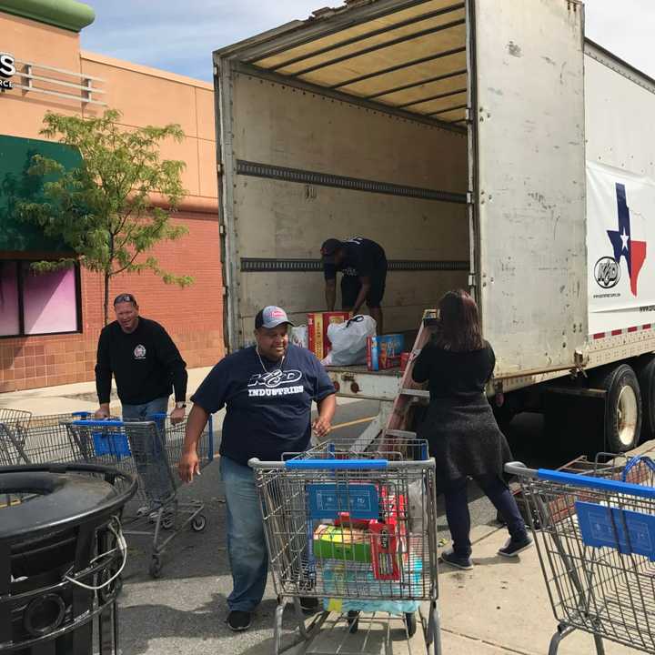 Karl Bjorkland helps collect supplies outside the Cortlandt Town Center for the victims of Hurricane Harvey.