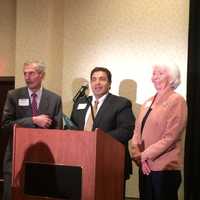 <p>Larry Ganim, center, a board member of Bridgeport-based Life presents the Community Impact Award to Ernest and Joan Trefz.</p>