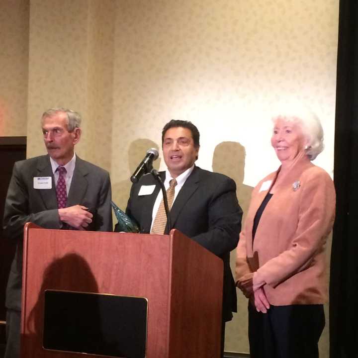 Larry Ganim, center, a board member of Bridgeport-based Life presents the Community Impact Award to Ernest and Joan Trefz.