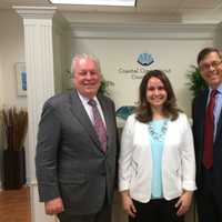 <p>First Selectman Michael Tetreau, left, and Economic Development Director Mark Barnhart, right, congratulate Alyssa Kolesar, owner of Coastal Connecticut Counseling in Fairfield.</p>