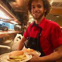 <p>Moises dishes up short stacks at IHOP on Cedar Lane in Teaneck.</p>