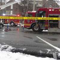 <p>A parking lot behind Mamaroneck Avenue near Maple Avenue was cordoned off Tuesday as White Plains firefighters battled a fire at the top of a four-story apartment building.</p>