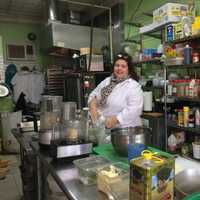 <p>Carol Lentini prepares dinner at The Nook in Bridgeport.</p>