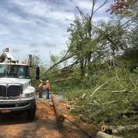 <p>Utility workers survey the damage in Putnam.</p>