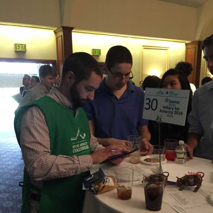 AITE Senior Daniel Ruskin works with a trader during a trading simulation in Stamford on Thursday.