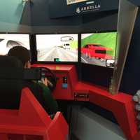 <p>A Trinity Catholic High School student drives a virtual car in a driving simulator Tuesday.</p>