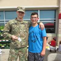 <p>Billy Cook meets a soldier at a signing event in Connecticut on Saturday.</p>