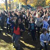 <p>Katonah resident Maria Colarco (in red) leads the Hillary Pantsuit Flashmob.</p>