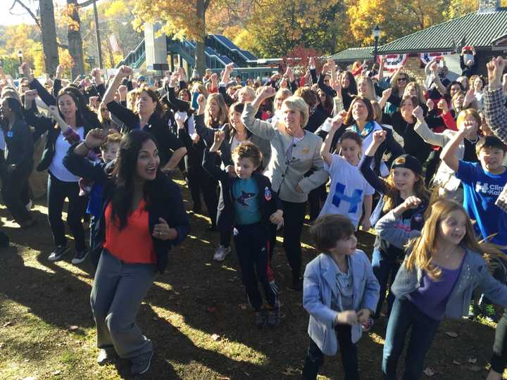 Katonah resident Maria Colarco (in red) leads the Hillary Pantsuit Flashmob.