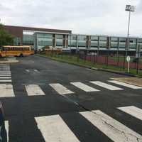 <p>Buses filled with children waited to pull out of the parking lot at Roger Ludlowe Middle School in Fairfield Thursday.</p>