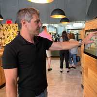 <p>Dan Mezzalingua demonstrates how to order on the touch-screens inside of Brine Fair Lawn.</p>