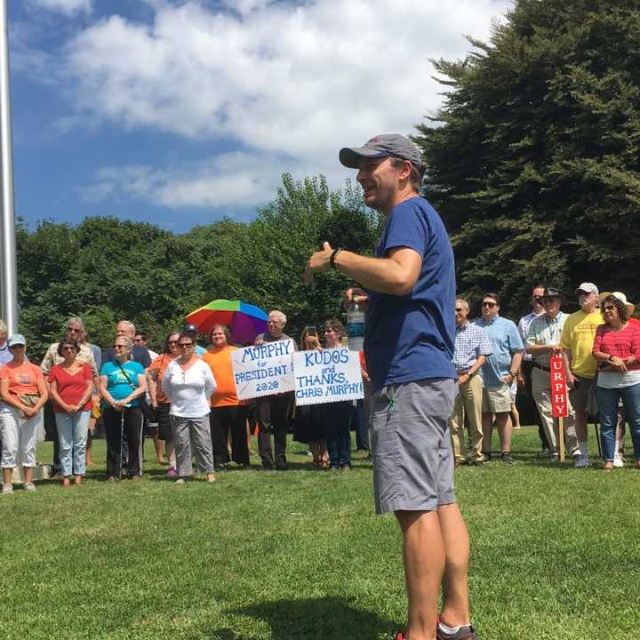 U.S. Chris Murphy is surrounded by a circle of supporters as he arrives in Rogers Park in Danbury after walking across the entire state of Connecticut.