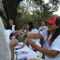 <p>A Freedom Walk volunteer distributes T-shirts.</p>