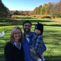 <p>Jared and Jessica Spingler with baby Liam at a charity golf outing for their family on Oct. 26. Jared has been staying home with Liam while Jessica goes to work part-time, earning 60% of her full-time salary.</p>