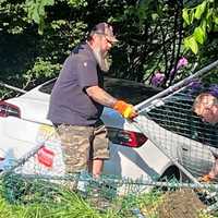 <p>Two Emerson Towing employees had to remove a section of fence before they could tow the vehicle out and onto a flatbed following the crash at Mill Street and First Avenue in Westwood around 5 p.m. Tuesday, May 23.</p>