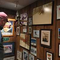 <p>Many of Hickory and Tweed's walls and counter tops are littered with photos of customers' families similar to anyone's house.</p>