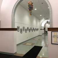 <p>Paper cranes hang from the ceiling at the Wall Of Remembrance exhibit in Newtown.</p>