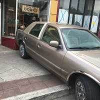 <p>A car backed into the front window of Brier Rose book store in Teaneck.</p>