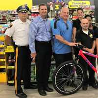 <p>Michael with his grandma, Officer Diaz, Dollar Store managers, Mayor Robert White, Police Chief Robert Kugler -- and his new bike.</p>