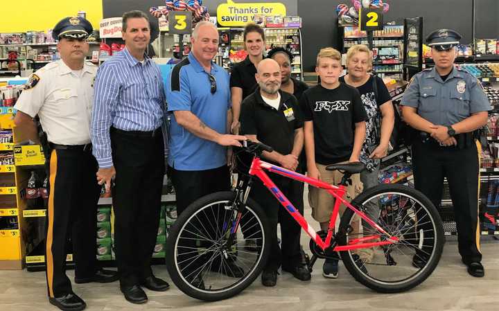 Michael with his grandma, Officer Diaz, Dollar Store managers, Mayor Robert White, Police Chief Robert Kugler -- and his new bike.