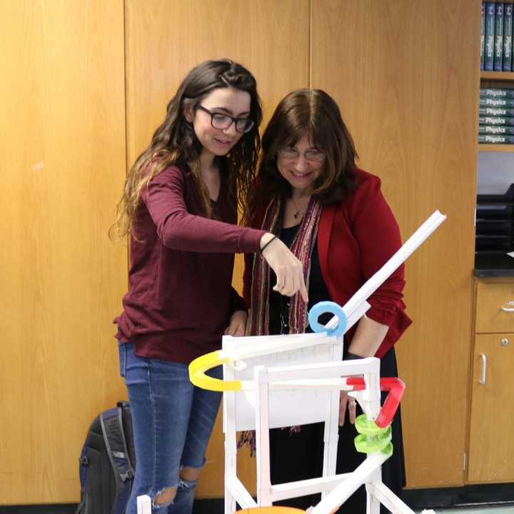 A Lakeland High School student explains the paper roller coaster recently built as a physics project.