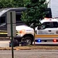 <p>The shaken driver sits on the curb on Spring Valley Road in Maywood after a young girl ran out in front of her car and was struck.</p>