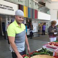 <p>A shopper peruses the selection at the farmers market at the Stamford Government Center Tuesday.</p>