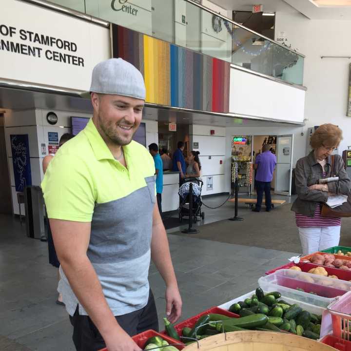 A shopper peruses the selection at the farmers market at the Stamford Government Center Tuesday.