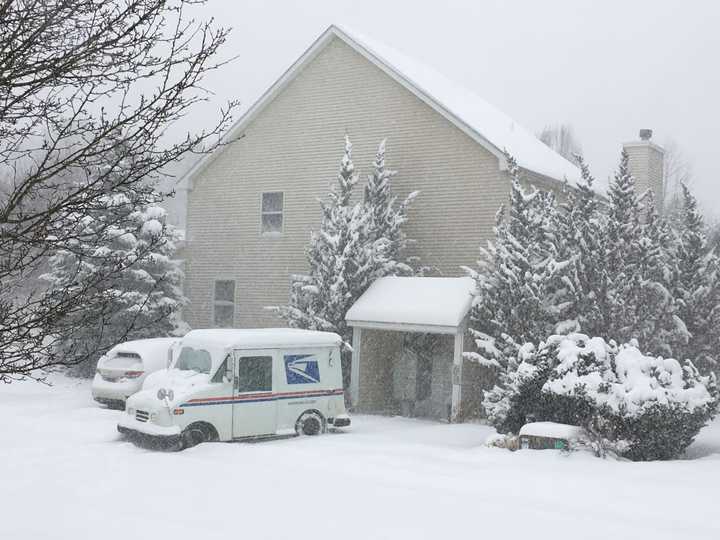 Neither rain nor snow nor dark of night: A postman makes his rounds on a stormy Thursday in Trumbull.