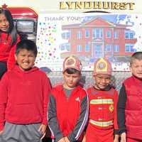 <p>The Washington School pupils signed a huge &quot;THANK YOU&quot; card with colored thumbprints.</p>