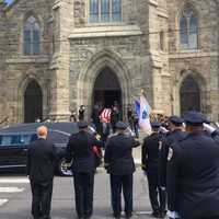 <p>The flag-draped coffin of Danbury Police Sgt. Drew Carlson leaves St. Peter&#x27;s Church after his Funeral Mass on Friday.</p>