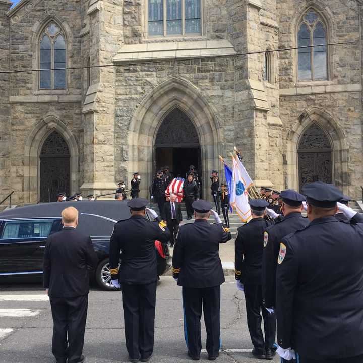 The flag-draped coffin of Danbury Police Sgt. Drew Carlson leaves St. Peter&#x27;s Church after his Funeral Mass on Friday.