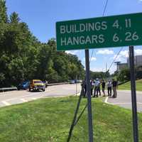 <p>News crews on the scene of an accident Monday that closed Airport Road near the Westchester County Airport following a police chase from Greenwich, Conn.</p>