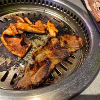 <p>Short ribs grilling in the middle of the dining table at KPOT.</p>