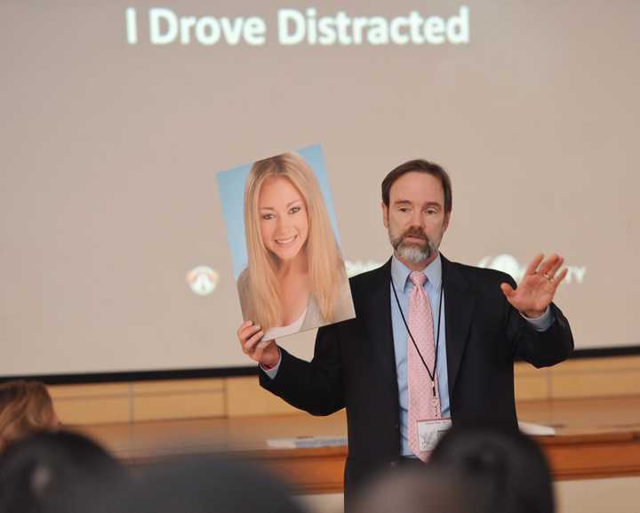 Joe Feldman, founder of End Distracted Driving, hold a picture of his daughter, Casey, who was killed by a distracted driver.