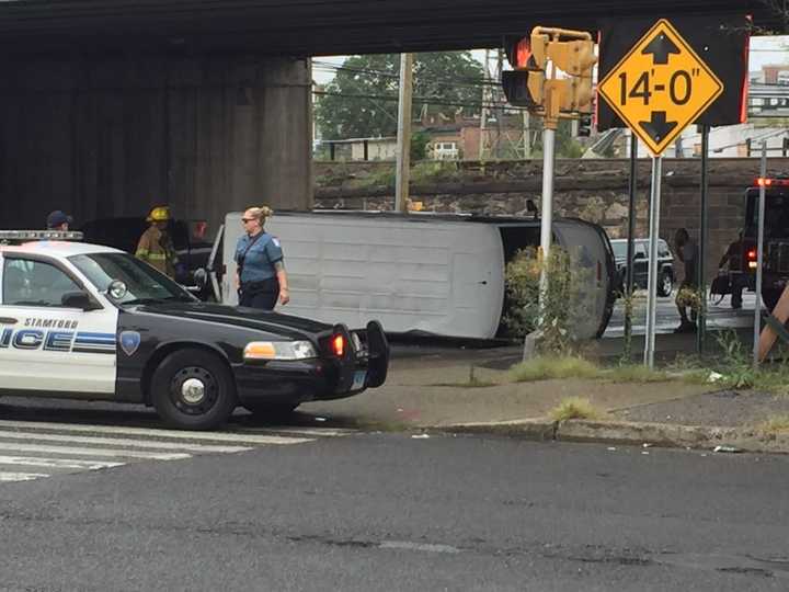 Police have blocked the road at the scene of a van rollover accident near downtown Stamford.